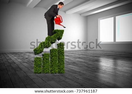 Businessman watering with red can against white big room with windows