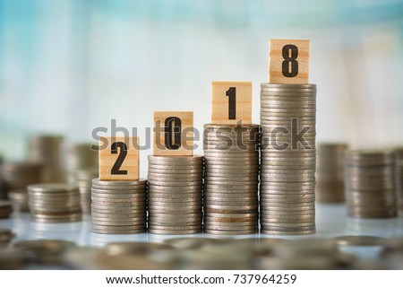 Stock of Coins with Wooden Scrabble Letters