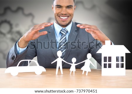 Businessman smiling behind car, family and house illustration against arrows with gears 