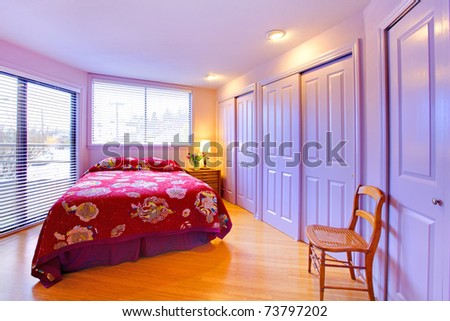 Purple lavender bedroom with closet doors and red bed