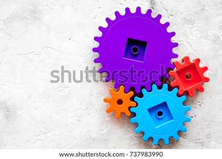 colorful gears for ideal team work technology stone table background top view mock-up