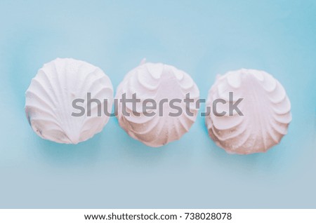 Pink and white marshmallows on blue background
