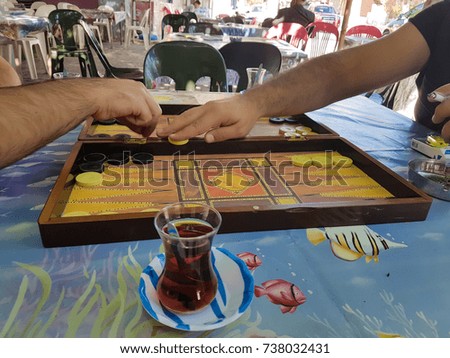 two people playing backgammon at a village coffeehouse