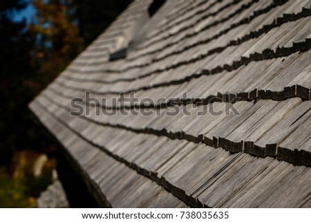A black forest farm roof of wooden shingles, picture taken from the side so there is a lot of depth of field