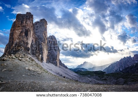Dusk time at Tre Cime di Lavaredo rocks profile in Dolomites with cloudy sky, South Tyrol. Dolomite Alps, Italy