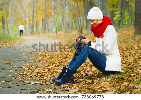 young girl photographes autumn forest