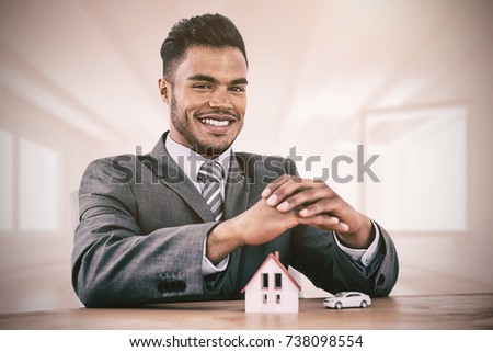 estate agent smiling against bright room with opened windows