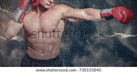 Bald boxer in fighting stance against digitally generated image of powder