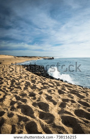 scenic sandy beach on atlantic coastline with breaking waves in blue sky, capbreton, les landes, france