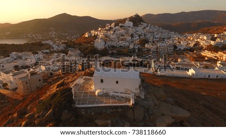 Aerial bird's eye view photo taken by drone of beautiful chora churches in Ios island at sunset, Cyclades, Greece