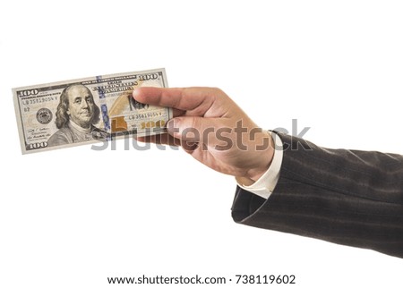 Business man in suit holds out hundred dollars isolated on white background
