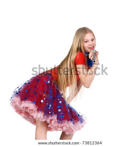 pretty teenage girl in a festive dress singing in the microphone