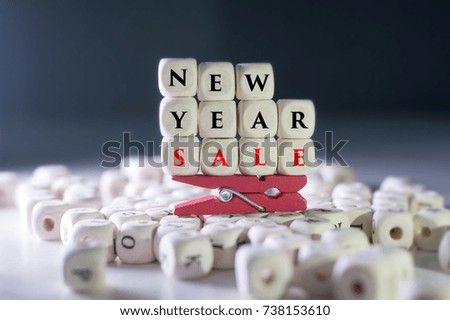 Close up shot.Alphabet Wooden Beads forming word New Year Sale on the white background.