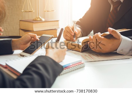 The hard work of an asian lawyer in a lawyer's office. Counseling and giving advice and prosecutions about the invasion of space between private and government officials to find a fair settlement. Royalty-Free Stock Photo #738170830