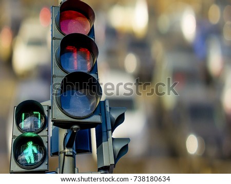 Pedestrian and car traffic lights with a timer on the background of cars on the road.