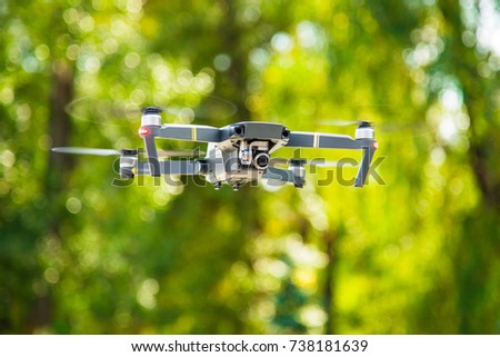 Drone flying during the day. Drone copter flying with a high-resolution digital camera. Closeup. The drone flies in the afternoon on a green background