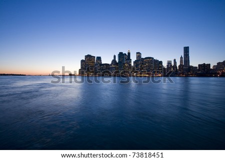 New York City Manhattan skyline at dusk over Hudson River with skyscrapers