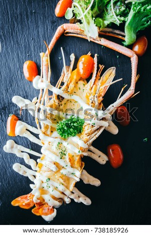 Grilled big prawn or shrimp with sauce on black tray