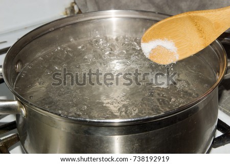In boiling water pour salt with a wooden spoon.