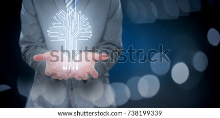 Midsection of businessman holding invisible object against defocused image of illuminated lighting equipment