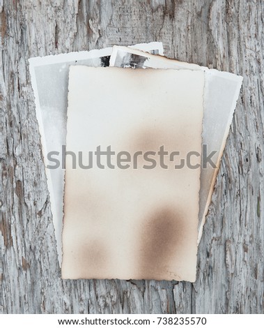 Vintage background with old photo paper on wood texture