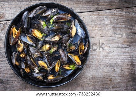 Traditional barbecue Italian blue mussel in white wine as top view in a casserole  Royalty-Free Stock Photo #738252436