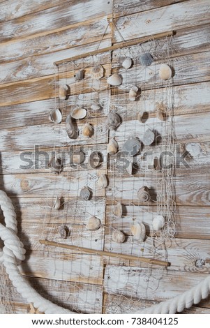 sea shells in a fishnet,on wooden board, summer vacation background