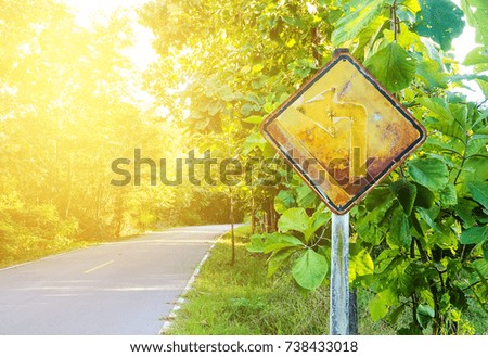 Yellow road sign in the countryside, beautiful trees, perfect nature.