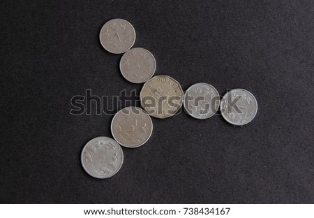 Indian currency coins on black background 