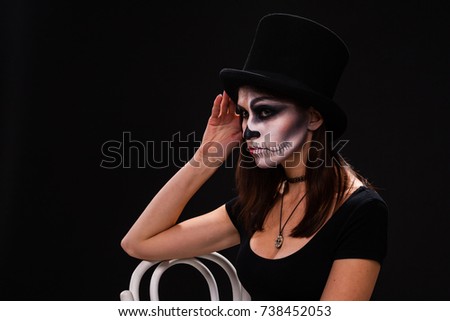 attractive young woman with gothic vampire makeup on helloween party over black background,halloween make up face