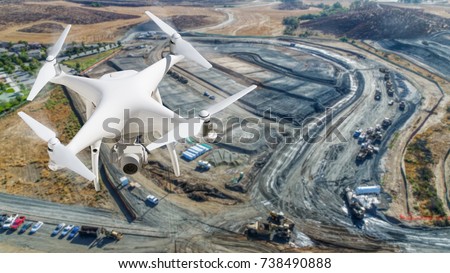 Unmanned Aircraft System (UAV) Quadcopter Drone In The Air Over Construction Site. Royalty-Free Stock Photo #738490888