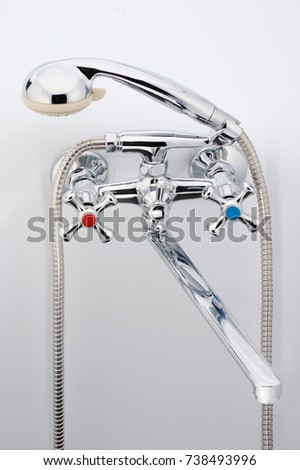 Mixer cold hot water on a white background. shower head. Chrome plated metal.