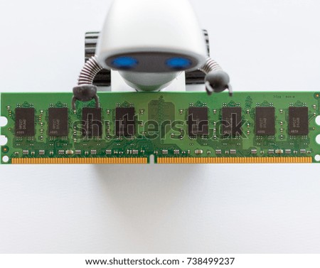 Close up top of view - Robot  with blue eyes carrying Computer Memory on a white background