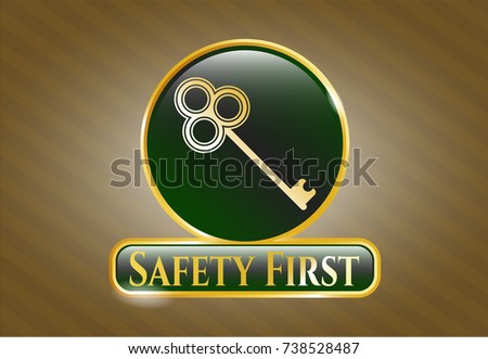  Gold emblem or badge with key icon and Safety First text inside
