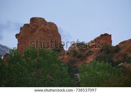 Different shapes of rock walls with trees and bushes at the Garden of the Gods, a National natural landmark in Colorado Springs, Colorado.