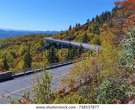 There's a half mile hike to get this view of Linn Cove Viaduct on the Blue Bridge Parkway in North Carolina.The photo of the parkway, fall colors & mountain background is taken from the top of a rock.