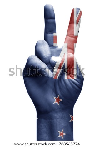 and making victory sign, New Zealand painted with flag as symbol of victory, win, success - isolated on white background