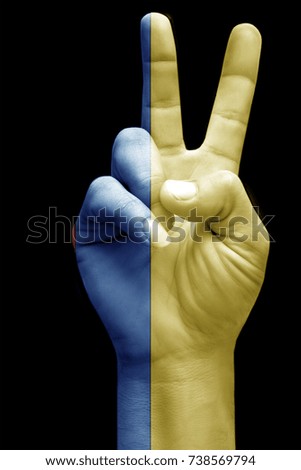 and making victory sign, Colombia painted with flag as symbol of victory, win, success - isolated on black background
