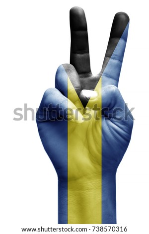and making victory sign, Bahamas painted with flag as symbol of victory, win, success - isolated on white background