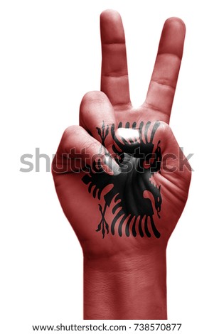 and making victory sign, Albania painted with flag as symbol of victory, win, success - isolated on white background