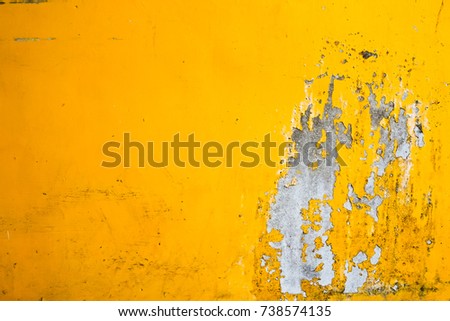 Cracked paint on old yellow wall texture Royalty-Free Stock Photo #738574135