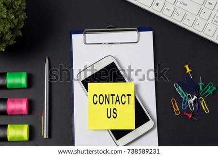 Contact us word on paper - office desk background
