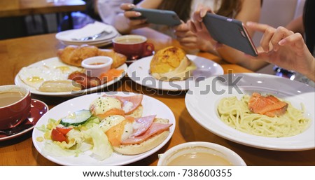 Women taking photo on English breakfast 