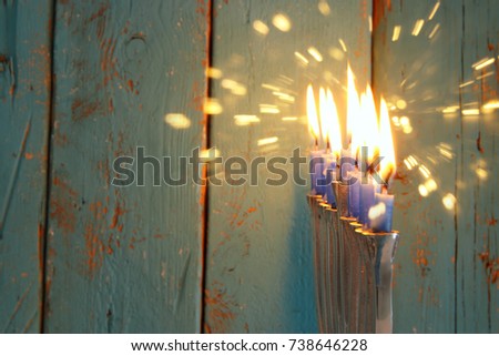 image of jewish holiday Hanukkah background with traditional menorah (traditional candelabra) and burning candles.