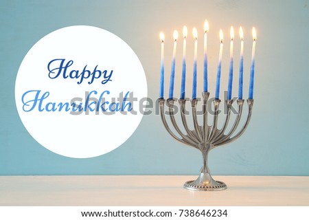 image of jewish holiday Hanukkah background with traditional menorah (traditional candelabra) and burning candles.