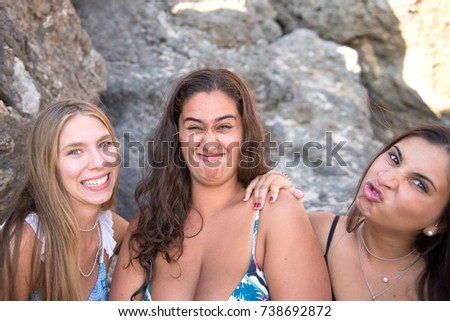 group of beautiful friends posing at the beach