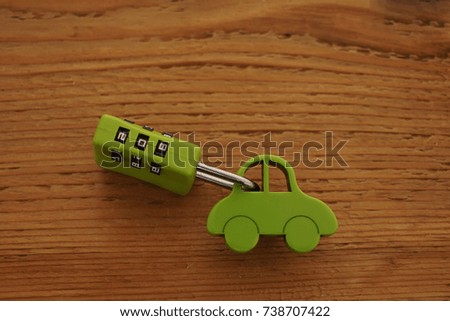 green car toy with  Key Code lock isolated on wooden background. car auto vehicle Security          