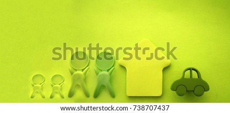 Concept security of property. Insurance home, car, money.protection from danger, providing security. Paper man, house and car on table with green theme background