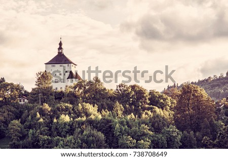 New Castle with forest in sunset, Banska Stiavnica, Slovak republic. Travel destination. Cultural heritage. Red photo filter.