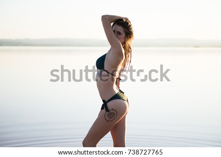 Young girl in green bikini at the beach